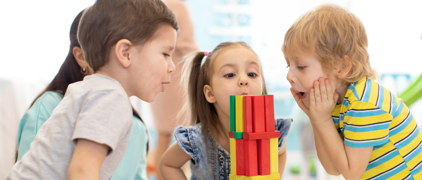 Dieses Bild zeigt Kinder beim Spielen mit Holzbausteinen.
