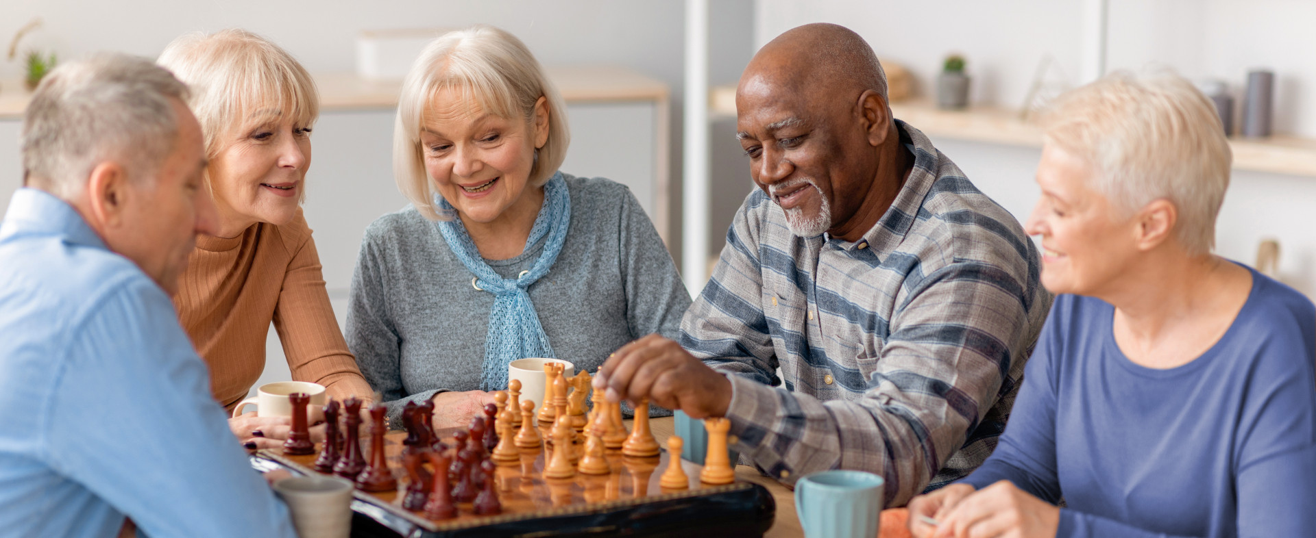 Multiracial senior people playing chess at nursing home Multiracial senior people playing chess at nursing home
